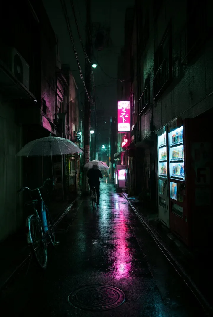 A rainy Tokyo alley at night with neon signs and a cyclist with a clear umbrella.